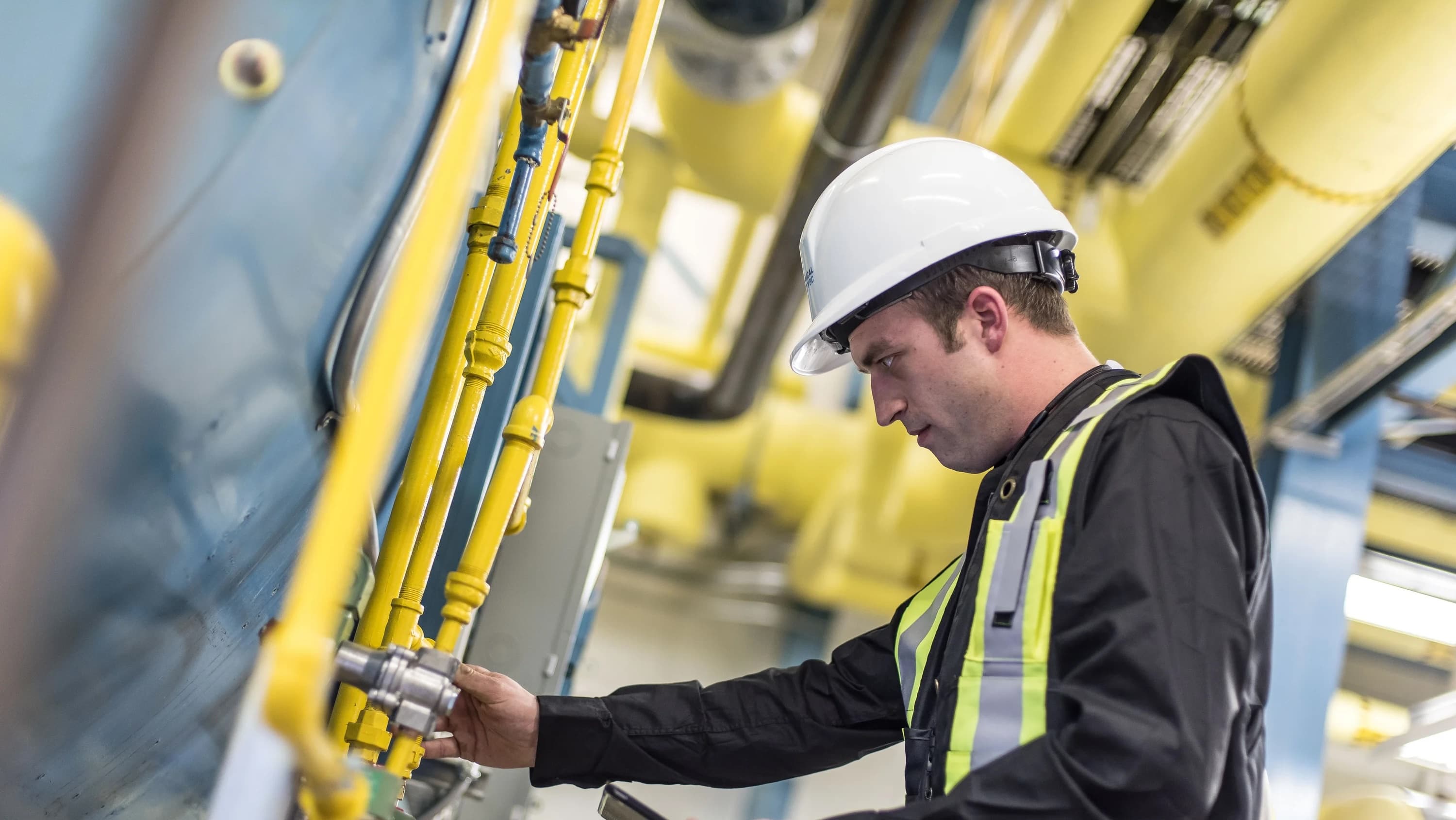A man inspecting a piece of equipment